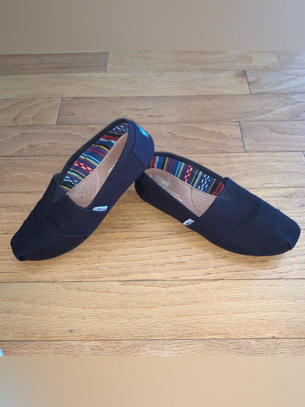 Toms Women’s Black Classic Canvas Slip-Ons, Multicolor Striped Lining, Size 8